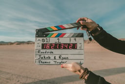 Person uses clapper board to film live action explainer video